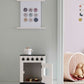 White wooden toy stove with the oven door open in a Scandi-style playroom